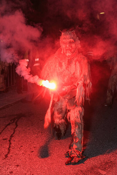 PODKOREN, SLOVENIJA - NOVEMBER 30th 2018: Unidentified man wears Krampus (devil) mask at traditional procession  "Parkelj gathering" in Podkoren, Slovenia