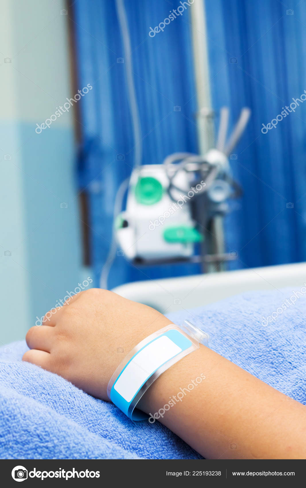 A Hand With An Iv And Hospital Bracelets