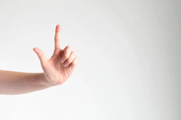 Una mano levantando el dedo índice para tocar algo delante de la vista . —  Fotos de Stock