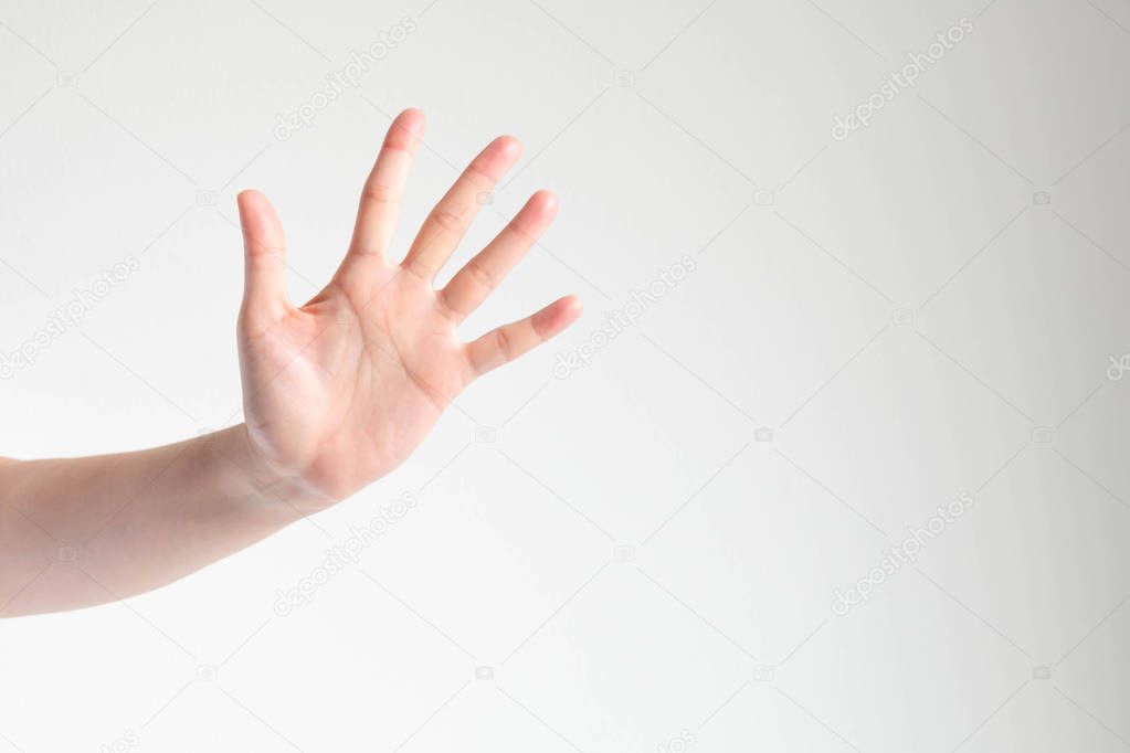 Woman showing a palm and raising five fingers on white background.