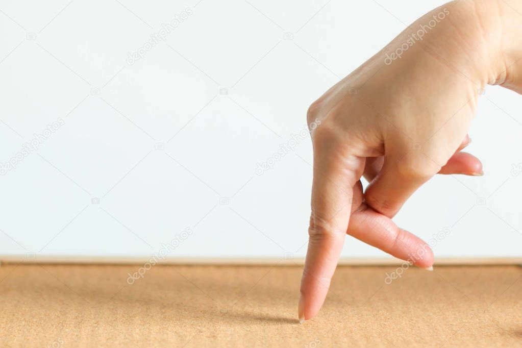 Walking hand symbol on wooden floor.