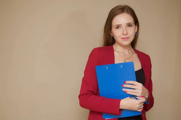 Happy beautiful business woman with clipboard in the office.