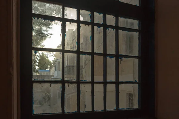 Old dirty window with broken glass, dust