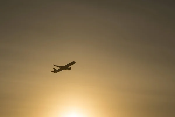 Silhouette of a plane taking off from the airport at sunset airport