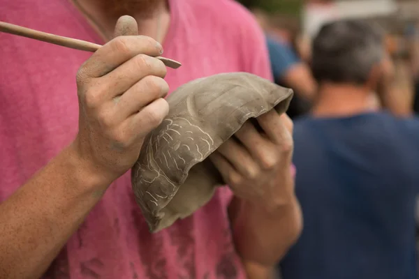 Close - up of the Potter's hand paints a pot pitcher of clay — Stock Photo, Image