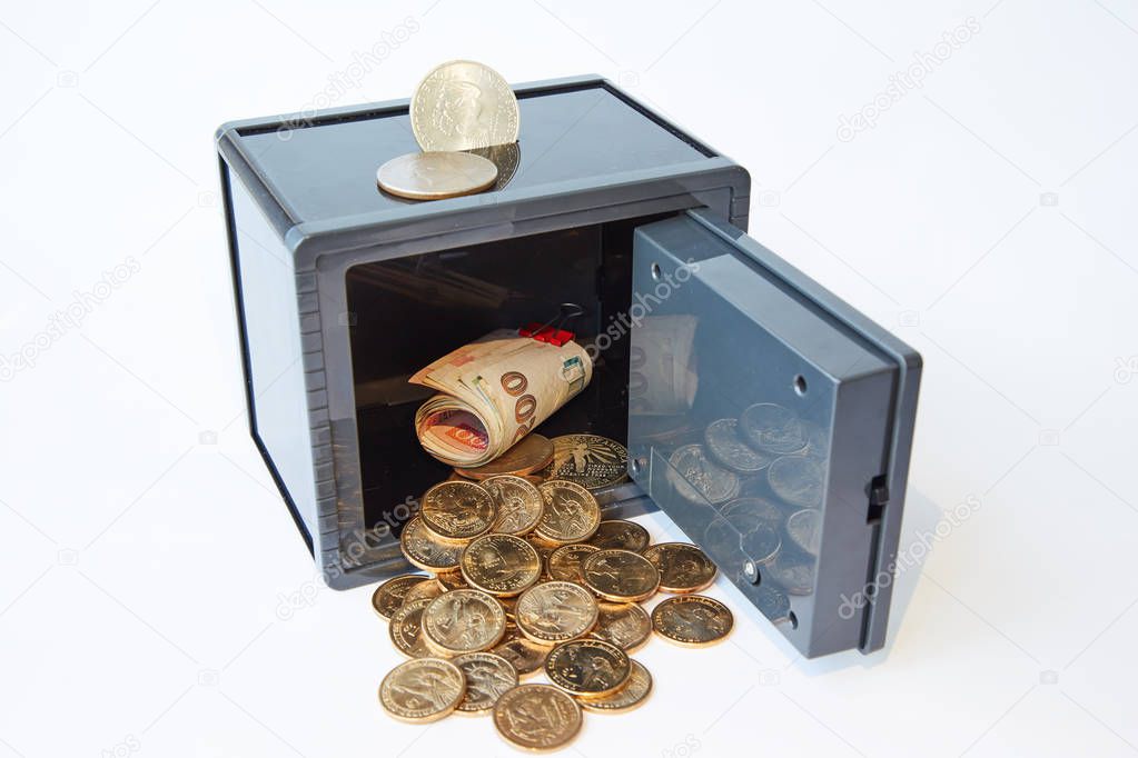 Yellow metal dollars and bills different currencies in gray safe, isolated
