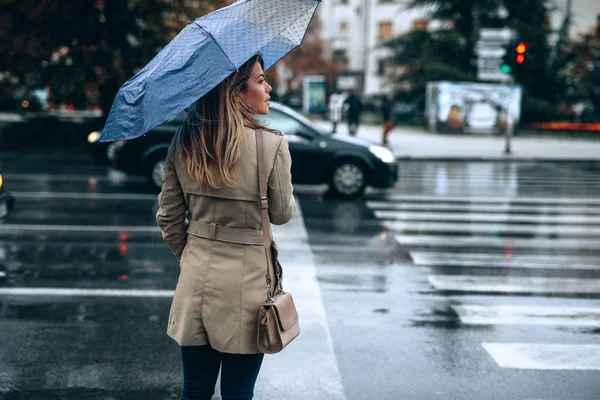 Beautiful woman with umbrella on a rainy day.