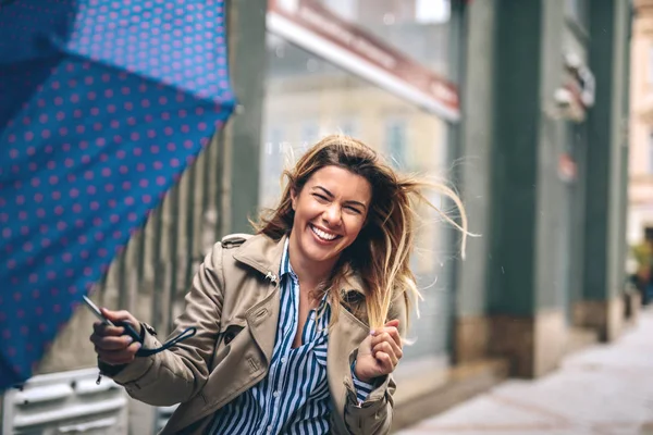 Beautiful woman with umbrella on a rainy day.