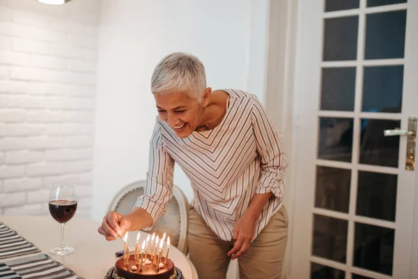 Senior Woman Setting Candles Festive Birthday Cake — Stock Photo, Image