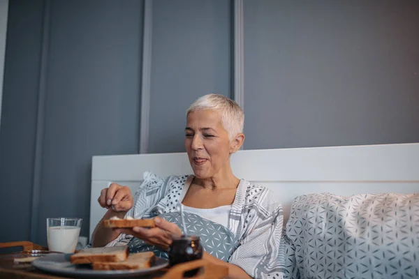 Senior Woman Eating Breakfast Bed — Stock Photo, Image