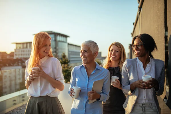 Business women having a meeting on coffee break on the rooftop.