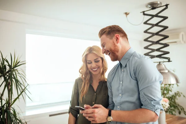 Casal Jovem Olhando Para Telefone Celular Rindo — Fotografia de Stock