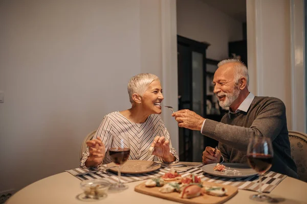 Elderly couple sharing food