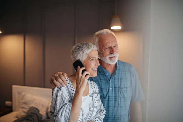 Elderly Couple Standing Window Woman Talking Phone — Stock Photo, Image