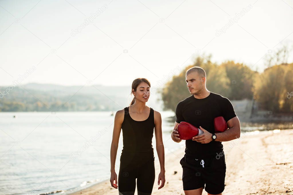 Her personal trainer is going over the technique as they are walking down the beach side. 