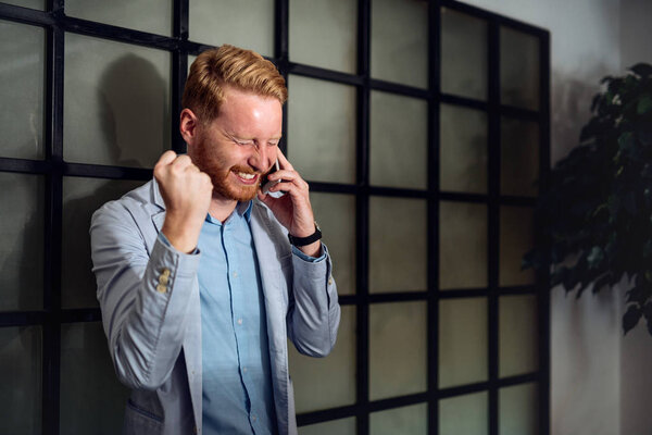 Successful businessman with clenched fist celebrating his success