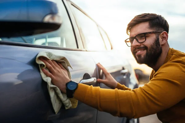 Lövés Egy Mosolygós Fiatalember Fényezése Kocsiját Egy Ruhával — Stock Fotó