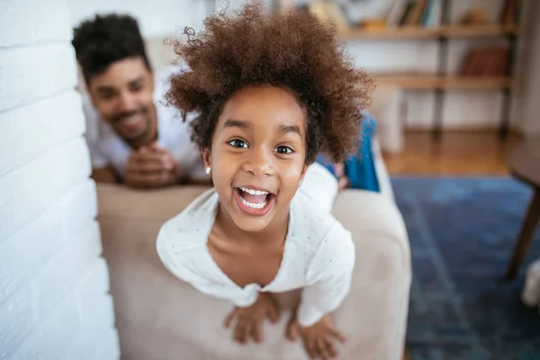 Portrait of a happy young afro girl at home.