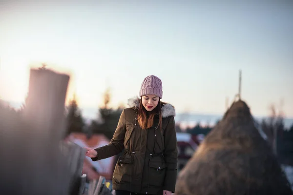 Portrait of a young woman walking on the countryside in winter.