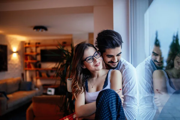 Portrait Young Couple Embracing While Sitting Next Window Home — Stock Photo, Image