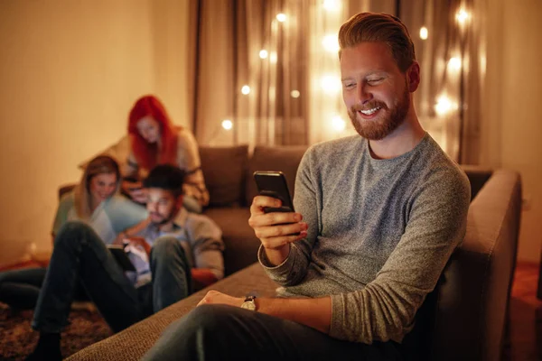 Porträtt Härlig Ung Man Använder Mobiltelefon Väns Hus — Stockfoto