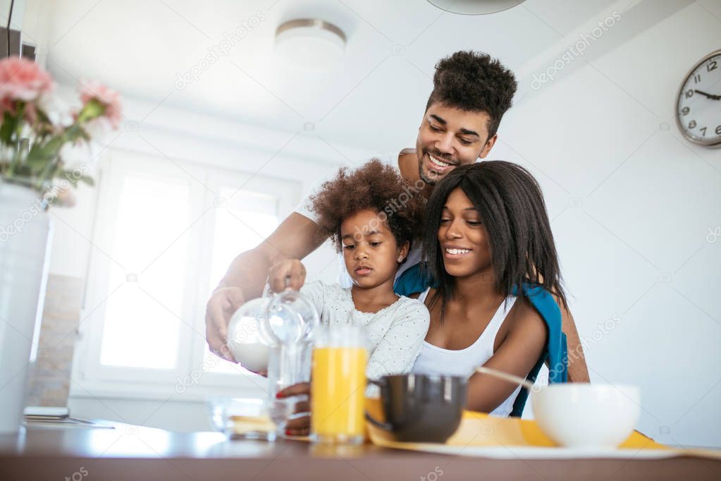 Photo of african american family having breakfast at home. 