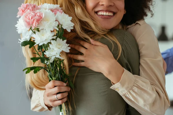 Portrait Two Women Hugging Each Other Holding Flowers Royalty Free Stock Photos