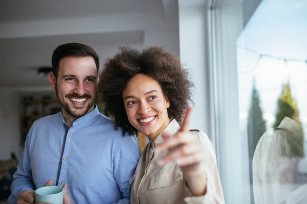 Happy Couple Looking Window While Drinking Coffee Stock Photo