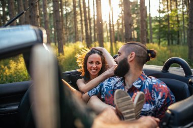 Güneşli bir günde bir Cabrio araba içinde mutlu bir genç Çift.
