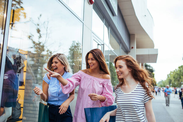 Portrait of three young woman shopping together.