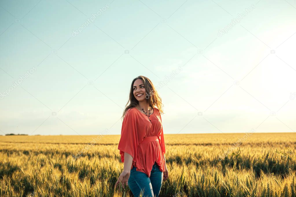Portrait of a beautiful woman walking in the fields.