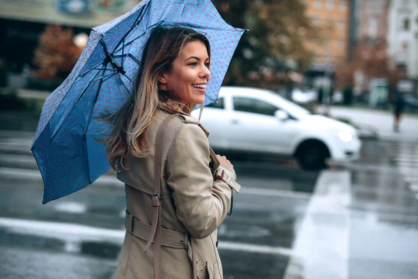 Beautiful woman with umbrella on a rainy day.