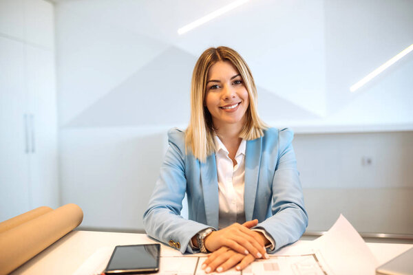 Portrait of a successful business woman sitting at the table.