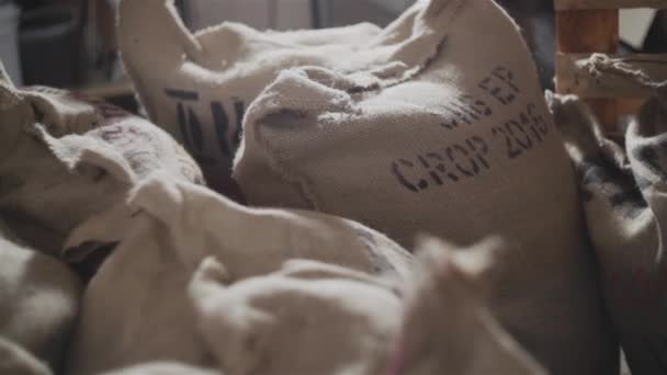 満ちている新鮮なキャンバス バッグのヒープ焼かれた穀物コーヒーとストアに配置 — ストック動画