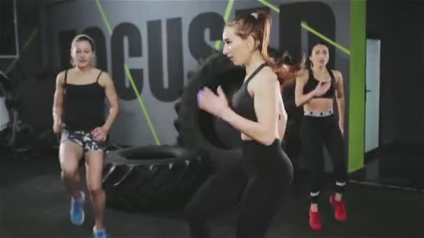 Drei Frauen beim Hochkniespringen im Fitnessstudio — Stockvideo