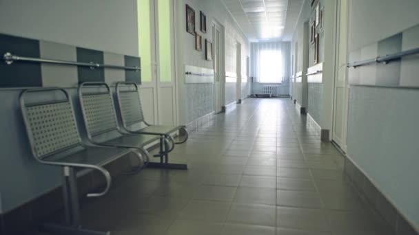 View of an empty corridor with benches — Stock Video