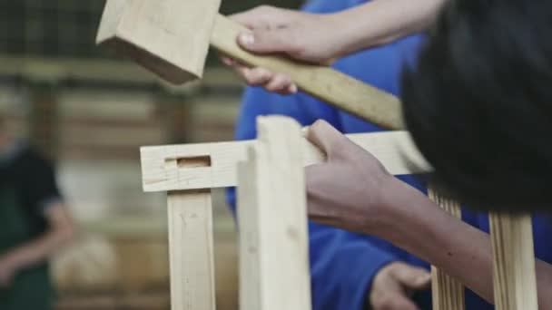 Crop view of group of woodworkers creating new piece of wood furniture in workshop. — Stock Video