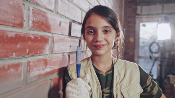 Teenage girl holding up paintbrush and smiling — Stock Video