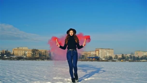 Stylish millennial woman with colored smoke bombs outdoors — Stock Video