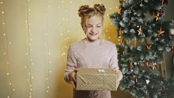 Excited young girl holding Christmas present — Stock Video