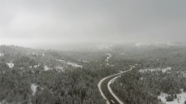 Vue par drone de la route dans les montagnes enneigées — Video