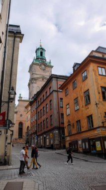 Gamlan Stan caddeleri. Gamla Stan 'in hareketli küçük adası Stockholm' ün Eski Kasabası. Kaldırım döşeli caddeler ve 17. ve 18. caddelerden kalma renkli binalar. 