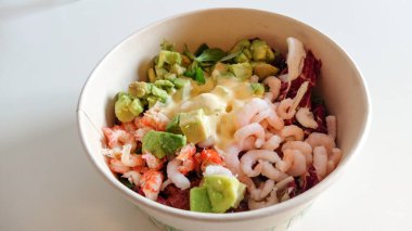 Salata, karides, avokado, sebze ve sostan oluşan güzel ve lezzetli bir salata.