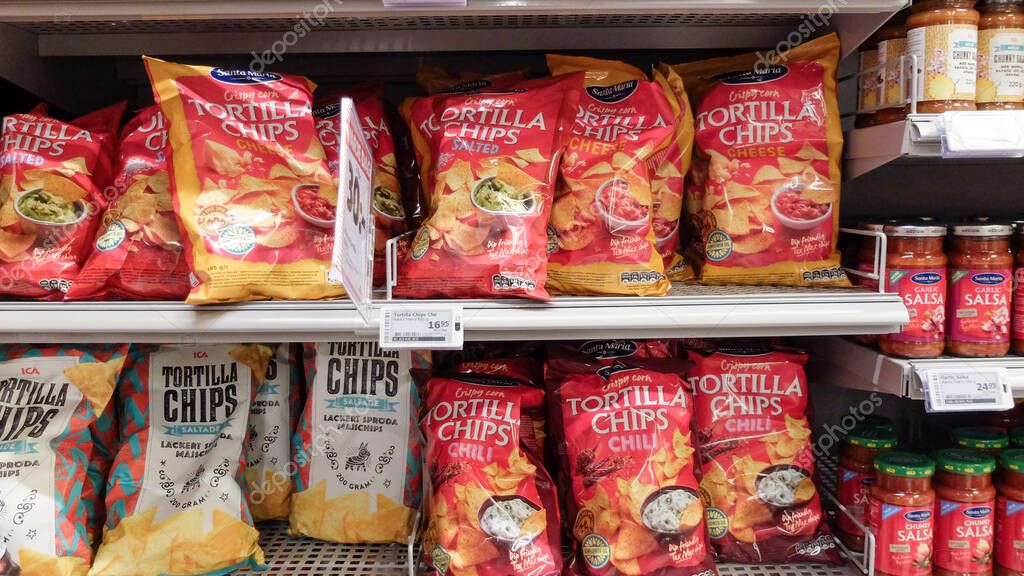 Tortilla Mexican chips and salsa sauce at the supermarket