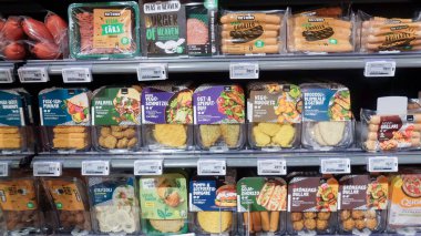 Vegetarian dishes, vegan imitations meats in a Swedish supermarket fridge clipart