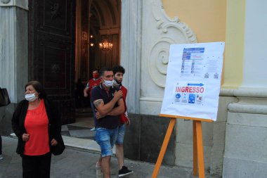 Minori, Sa, İtalya - 11 Haziran 2020: Dini kutlamalar sona erdikten sonra Santa Trofimena Bazilikası 'ndan çıkışta sadık. Covid-19 'un 3 aşamasında acil durum maskeleri ve sosyal mesafe