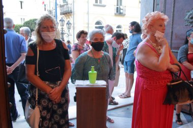 Minori, Sa, İtalya - 13 Temmuz 2020: Kiliseye girmeden önce inananlar, halka açık yerlerde covid-19 enfeksiyonunu önlemek için ellerine bir dezenfekte sıvısı verdiler.