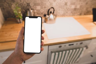 Erkek el eve iç arka plan üzerinde siyah smartphone boş beyaz ekran ile tutarak