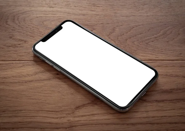 Smartphone Mit Leerem Bildschirm Rahmenlos Auf Holztisch Liegend — Stockfoto