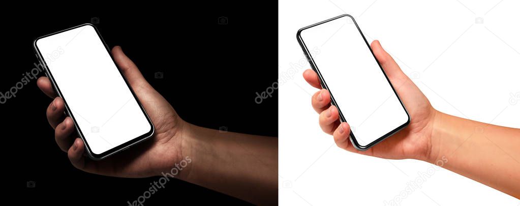 Woman hand holding the black smartphone with blank screen and modern frame less design angled position - isolated on black and white background